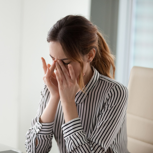 woman rubbing eyes