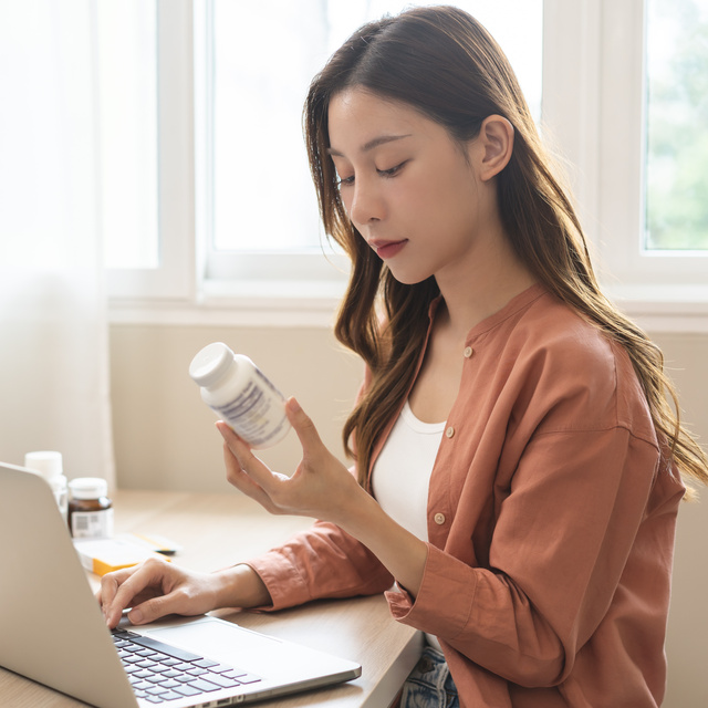 woman inspecting medication